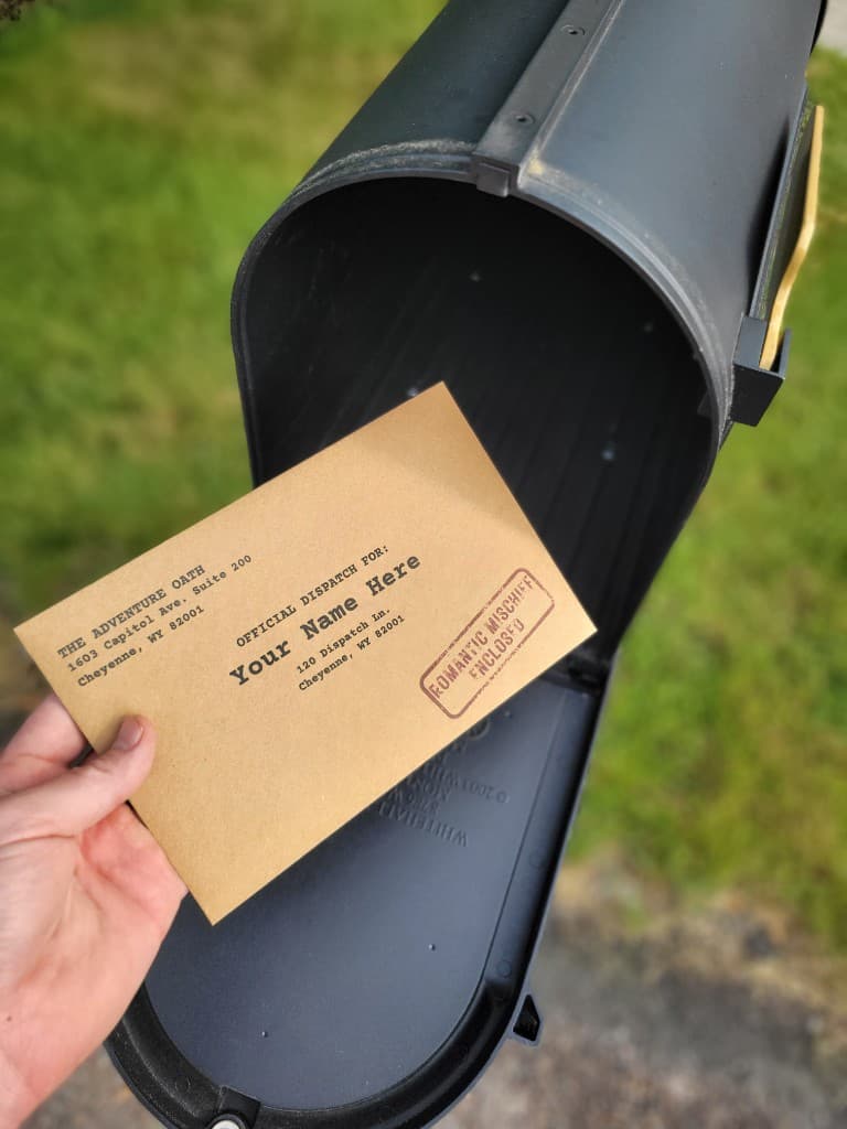 Holding an Adventure Oath official dispatch envelope at the mailbox